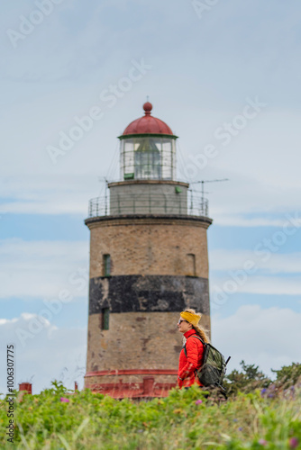 Young woman hiking the historic Falsterbo Lighthouse in Sweden photo