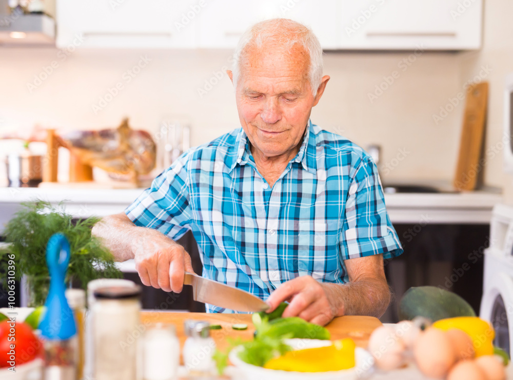 Senor man preparing fresh vegetable salad at home in the kitchen Senor man preparing fresh vegetable salad at home in the kitchen
