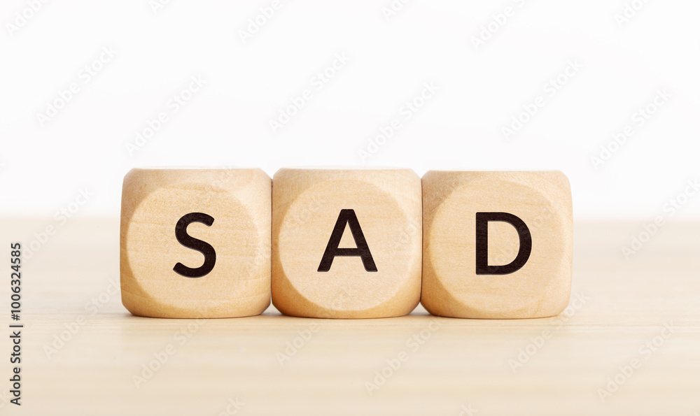 Sad word on a group of wooden blocks. White background with Copy space Sad word on a group of wooden blocks. White background with Copy space