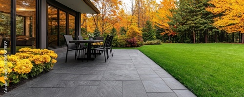 Panel kuchenny z motywem Elegant stamped concrete patio resembling natural slate, with textured finishes and earthy tones, enhancing a backyard setting