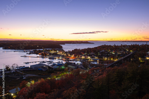 Aerial view of Parry Sound, Ontario, Canada downtown and waterfront with moored sail boats, cruise ships, docks, restaurants and marinas shot at sunset time.