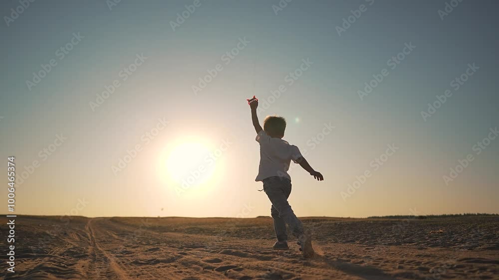 Boy run with kite at sunset. Silhouette happy boy fly kite in open field. child run freely as kite soars through sky. Scenic sunset adds warmth to the moment. Boy enjoying outdoor fun with kite sunset Boy run with kite at sunset. Silhouette happy boy fly kite in open field. child run freely as kite soars through sky. Scenic sunset adds warmth to the moment. Boy enjoying outdoor fun with kite sunset