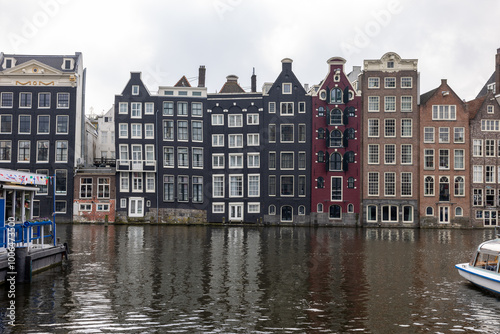 Typical gabled houses on Damrak district in  Amsterdam, Netherlands