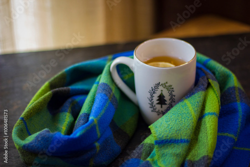 Cup of hot tea with lemon and coffin scarf.
