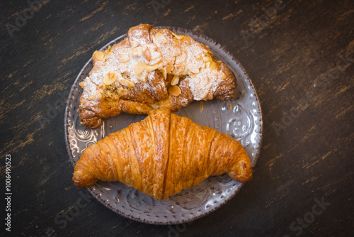 close-up of croissants stacked on wooden table.