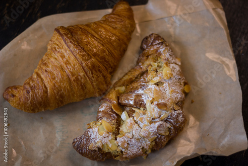 close-up of croissants stacked on wooden table.