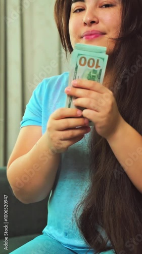 vertical footage excited smiling woman showing cash money 100 american dollars banknotes, hands with money close up, Income, winner and Business concept. High quality 4k footage