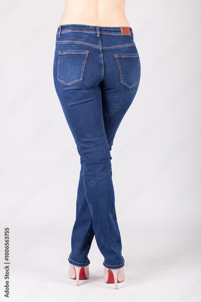 Close up of woman wearing blue jeans. Fit female blue jeans. Close up of woman wearing blue jeans. Fit female blue jeans.