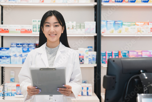 Portrait of asian female young pharmacist druggist checking drugs medicines pills remedies on prescription on clipboard using computer at cash point desk in drugstore pharmacy Free Download Portrait of asian female young pharmacist druggist checking drugs medicines pills remedies on prescription on clipboard using computer at cash point desk in drugstore pharmacy - GFXLoad