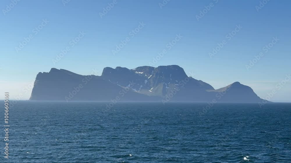 Nordfugløya, Nuorta-Vuovlá, Vannvåg, Karlsøy Municipality, Troms, Norwegen - uninhabited nature reserve island partially snow covered mountain top of Fugløykallen Nordfugløya, Nuorta-Vuovlá, Vannvåg, Karlsøy Municipality, Troms, Norwegen - uninhabited nature reserve island partially snow covered mountain top of Fugløykallen