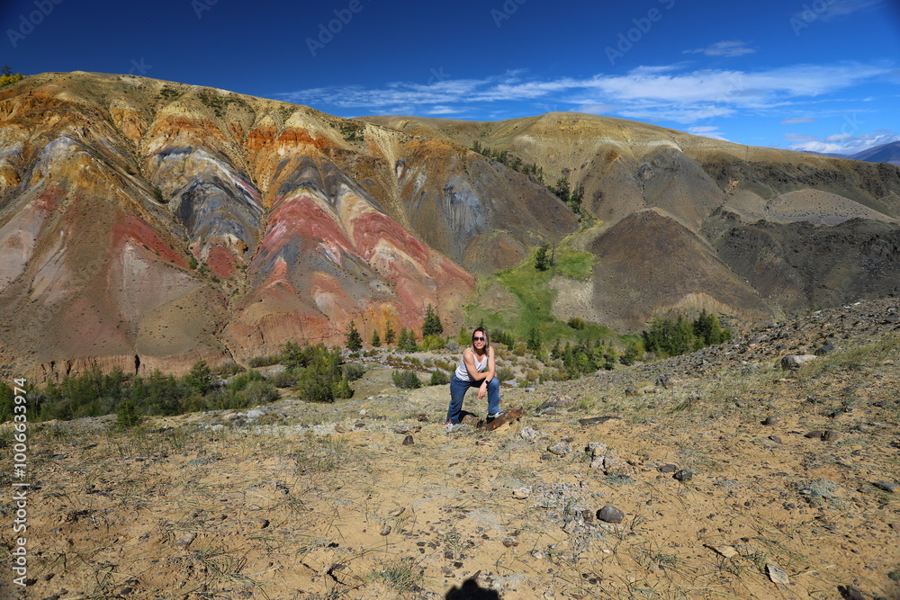 Altai Republic. Tourists pose against the background of Martian and Moon landscapes – deserted area with canyons. Altai Republic. Tourists pose against the background of Martian and Moon landscapes – deserted area with canyons.