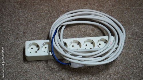 Old electric extension cable on floor