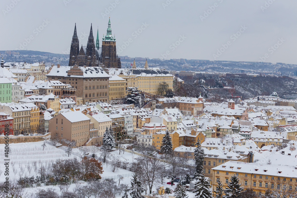 Snowy Prague City with gothic Castle from the Hill Petrin, Czech republic