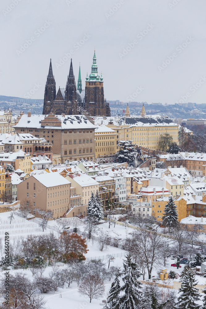 Snowy Prague City with gothic Castle from the Hill Petrin, Czech republic