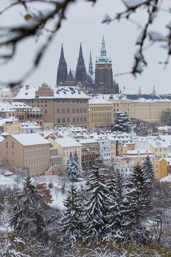 Snowy Prague City with gothic Castle from the Hill Petrin, Czech republic