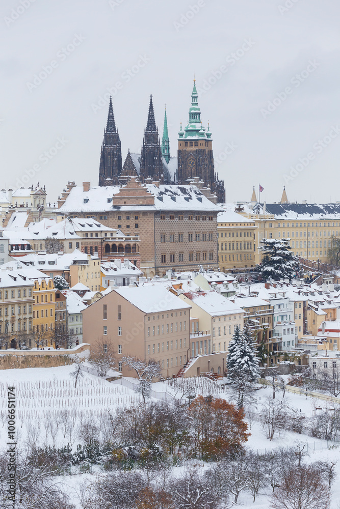 Snowy Prague City with gothic Castle from the Hill Petrin, Czech republic