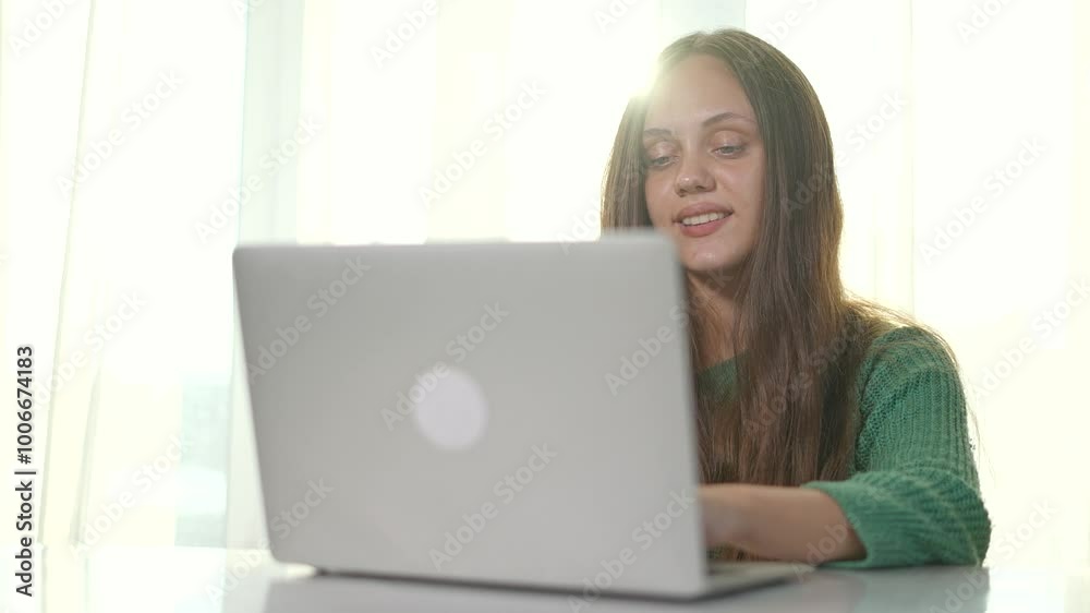 Woman working on laptop in office. Businesswoman focused on laptop screen. Smiling professional enjoying productive business work. Modern woman using laptop for business tasks in bright office space. Woman working on laptop in office. Businesswoman focused on laptop screen. Smiling professional enjoying productive business work. Modern woman using laptop for business tasks in bright office space.