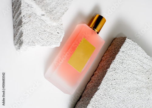 Elegant Peach Color Spray Perfume Bottle on White Stone Background - Minimalist Fragrance Mockup photo