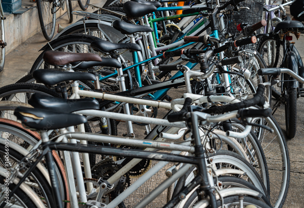 Row of Bicycles parked in front of Second-hand bike Shop in bangkok. A lot of old bicycles different brand names parked on the street, Many second hand bikes for sale, Space for text, Selective focus. Row of Bicycles parked in front of Second-hand bike Shop in bangkok. A lot of old bicycles different brand names parked on the street, Many second hand bikes for sale, Space for text, Selective focus.