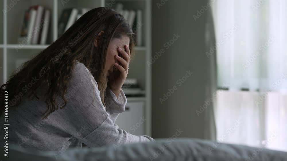 Young Asian woman sitting in a bedroom, feeling sad tired and worried suffering depression in mental health. in concept of depression anxiety and insomnia