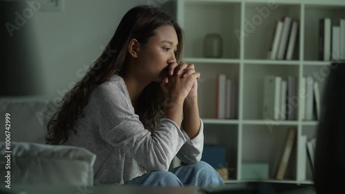 Young Asian woman sitting in a bedroom, feeling sad tired and worried suffering depression in mental health. in concept of depression anxiety and insomnia