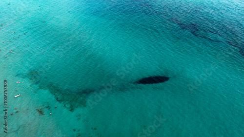 Aerial view of people bathing in the ocean.