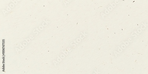 Close-up of a textured, off-white paper surface with subtle flecks of brown.