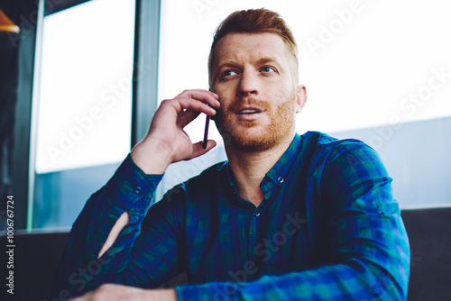 Εκτύπωση καμβά Serious red head hipster guy making important conversation with customer service