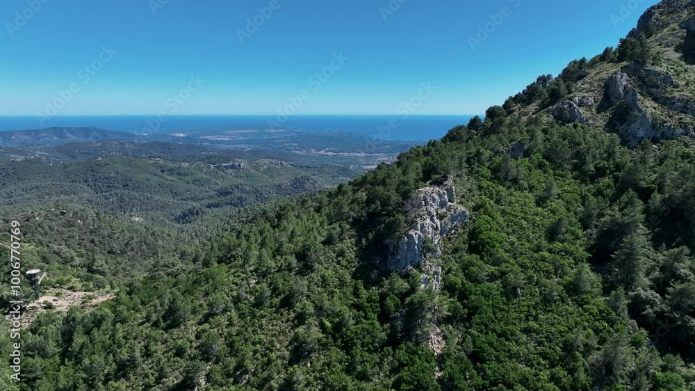 Drone flying over green mountain with great view to the sea on mallorca, Spain Drone flying over green mountain with great view to the sea on mallorca, Spain