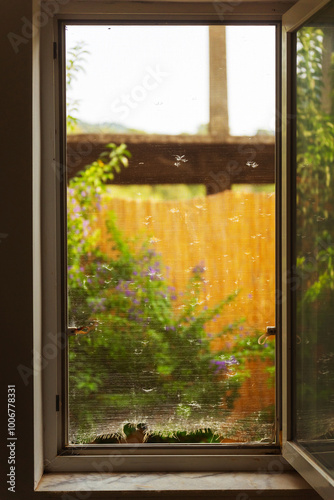 Old mosquito net with holes on the window