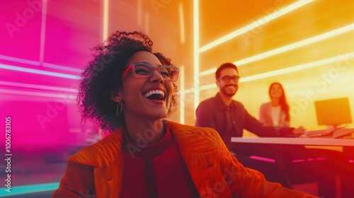 Smiling African American woman enjoying a creative and modern workspace with vibrant pink and orange neon lighting, accompanied by diverse colleagues in a futuristic office setting