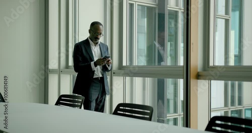 Wallpaper Mural Businessman on a Phone Call in an Empty Office Conference room Looking out of the window Torontodigital.ca