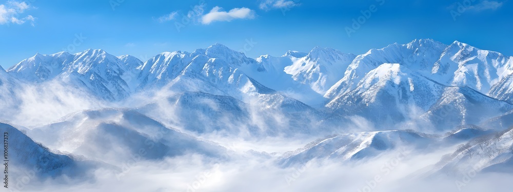 A snow-covered mountain range under a clear blue sky, with white clouds swirling around the peaks. A snow-covered mountain range under a clear blue sky, with white clouds swirling around the peaks.