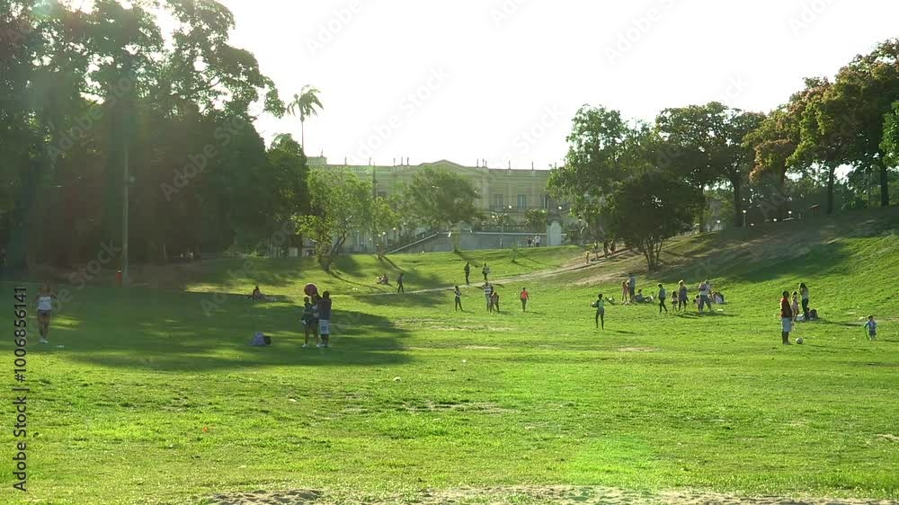 Lively park scene at Quinta da Boa Vista with people enjoying outdoor activities on a sunny day. Palácio Nacional Museu Lively park scene at Quinta da Boa Vista with people enjoying outdoor activities on a sunny day. Palácio Nacional Museu