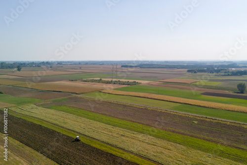 Aerial view of vibrant agricultural fields showcasing diverse crops and rich textures under a clear sky