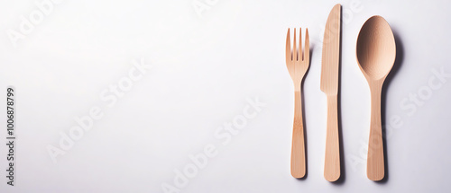 Cutlery set featuring a knife, fork, and spoon on a white isolated background.