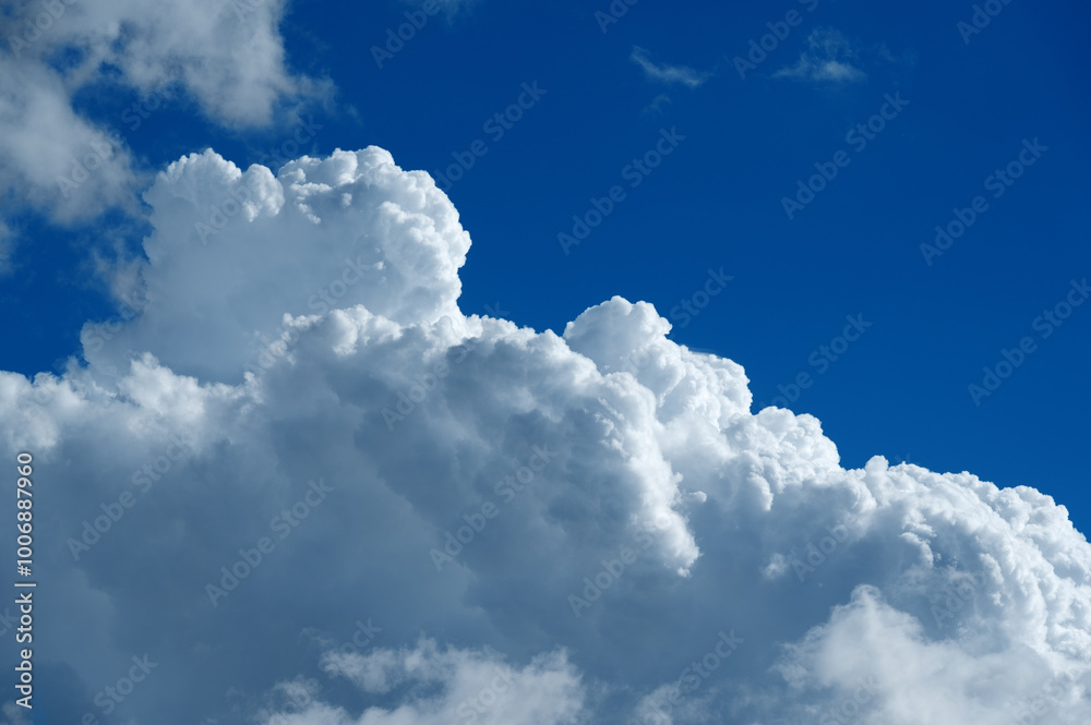 a large white cumulus cloud with blue sky a large white cumulus cloud with blue sky