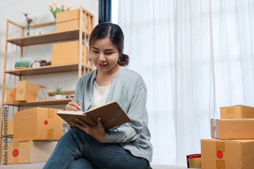 Young Woman Packing Boxes of Merchandise for Online Sales in a Modern Home Setting