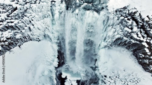 Waterfall in Iceland, Frozen river in winter, Magical location of snow and ice, Magical winter landscape in the northern country, Svodufoss photo