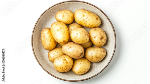 Freshly harvested small potatoes displayed in a bowl on a white background