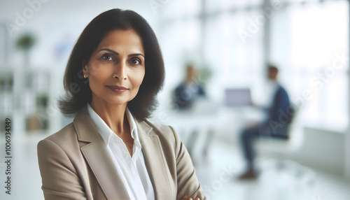 strong middle age business women Indian face look entrepreneur serious smile on face office background space hair successful lady executive standing work culture portrait senior hand arm crossed girl