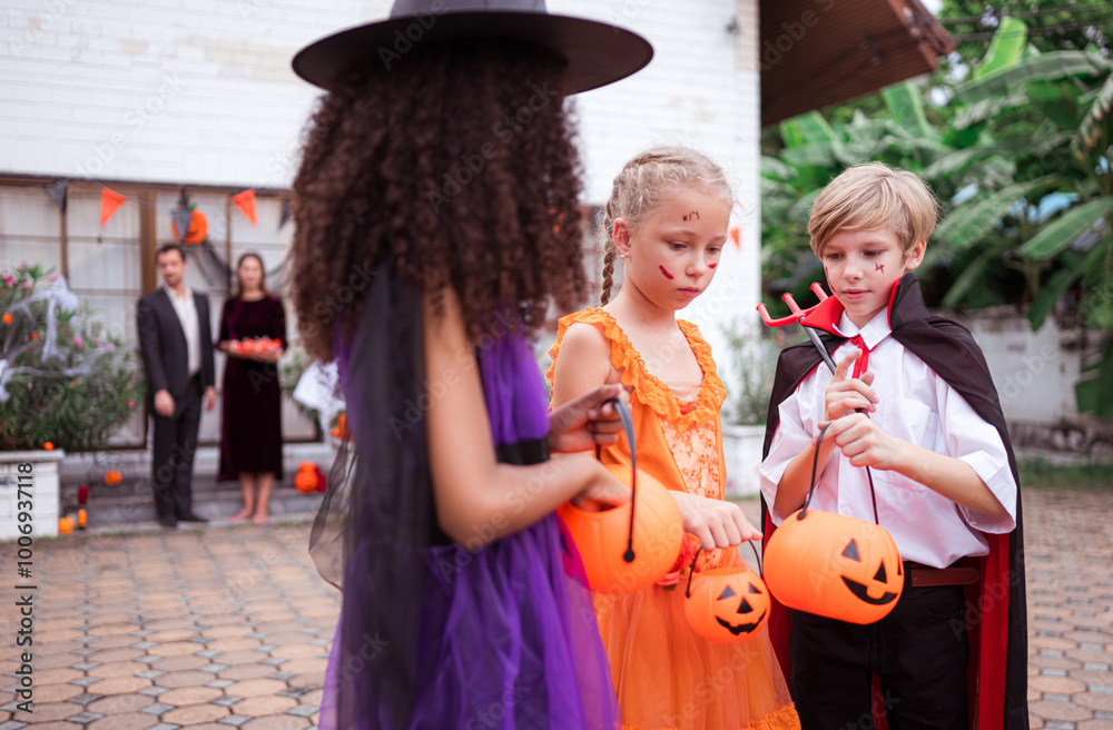 Obraz premium Children in ghost costumes are having fun trick-or-treating on Halloween