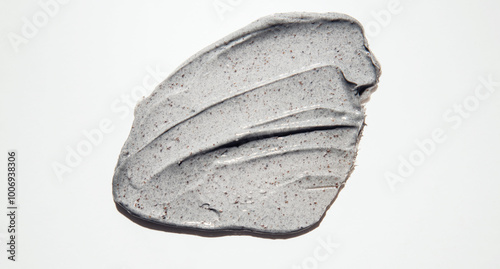 Close-up of a smear of a skin scrub on a white background. Texture of skin care cosmetic product. Cleansing and exfoliating your skin.