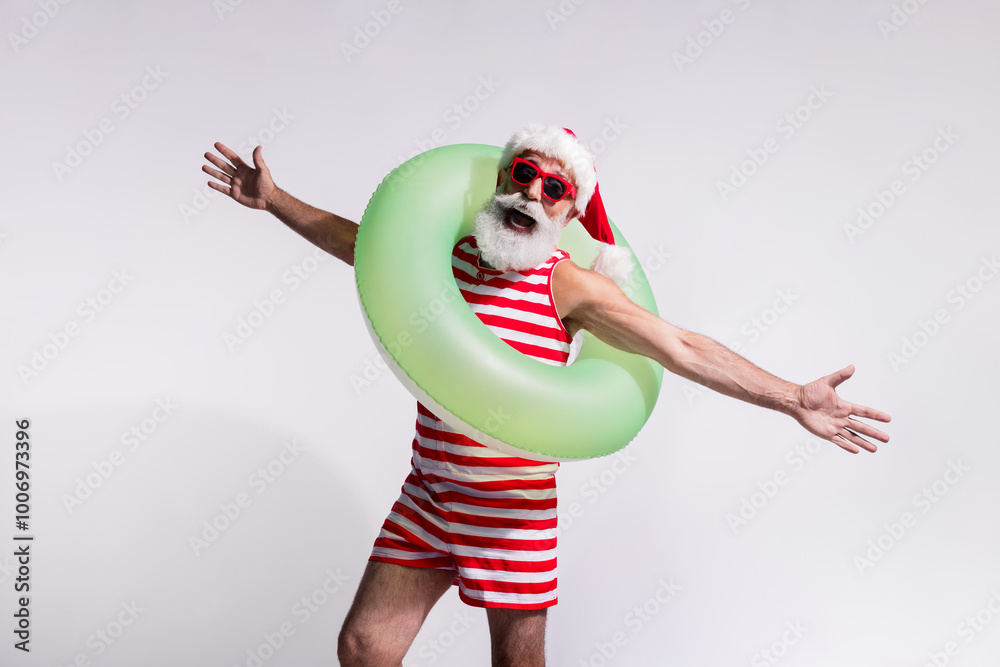 Photo of santa in red striped swimwear open hand summer season sea vacation isolated on white sandy beach background