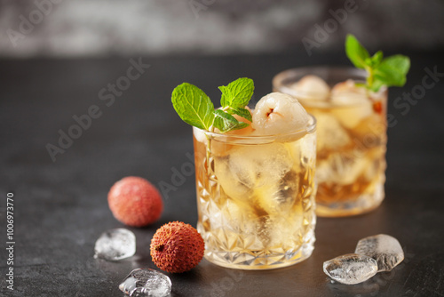 Lychee iced tea with mint leaves in drinking glass. Refreshment drink photo