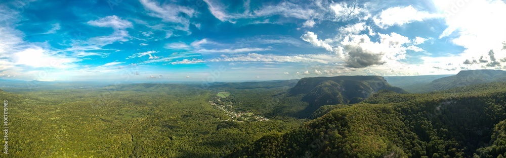 Obraz premium large aerial view panorama of the surroundings of the village Guamka, surrounded by green forest (western Caucasus, Russia) on a sunny summer day