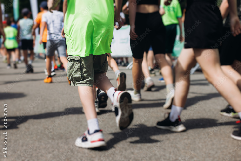 Children marathon runners crowd, young teen sportsmen participants start running in the city streets, crowd of kids joggers in motion, kid group athletes outdoor run, family competition in summer day Children marathon runners crowd, young teen sportsmen participants start running in the city streets, crowd of kids joggers in motion, kid group athletes outdoor run, family competition in summer day