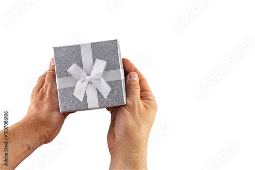 The man holds in his hand a decorative gift box with a silver lid and a white bow