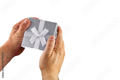 The man holds in his hand a decorative gift box with a silver lid and a white bow