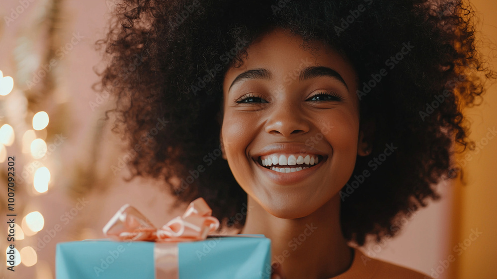 Joyful person smiling while holding beautifully wrapped gift, expressing happiness and surprise. warm background adds to cheerful atmosphere Joyful person smiling while holding beautifully wrapped gift, expressing happiness and surprise. warm background adds to cheerful atmosphere